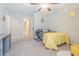 Bright bedroom with gray carpet, a ceiling fan, and decor in gray and yellow at 13527 Willow Bluestar Loop, Riverview, FL 33579