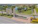 Beautiful entrance to the Pradera community featuring stone pillars, a water feature, and manicured landscaping at 13527 Willow Bluestar Loop, Riverview, FL 33579