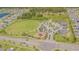 Aerial view of a community park with playground, open field, and gathering space surrounded by homes at 13527 Willow Bluestar Loop, Riverview, FL 33579