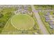 Aerial view of a neighborhood park featuring a large green space, playground, and walking trails at 13527 Willow Bluestar Loop, Riverview, FL 33579