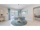 Cozy dining area features a round table, comfortable blue chairs, and sliding door access at 13527 Willow Bluestar Loop, Riverview, FL 33579