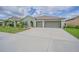 Charming single-story home with a well-manicured lawn and a spacious three-car garage at 13527 Willow Bluestar Loop, Riverview, FL 33579