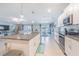 Open-concept kitchen view showcasing stainless steel appliances and eat-in dining adjacent to living area at 13527 Willow Bluestar Loop, Riverview, FL 33579