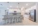 Modern kitchen with a large island, stainless steel appliances, and stylish bar stool seating at 13527 Willow Bluestar Loop, Riverview, FL 33579