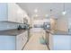 Bright, modern kitchen features granite countertops, stainless appliances, and white cabinetry at 13527 Willow Bluestar Loop, Riverview, FL 33579