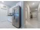 Kitchen view featuring stainless steel refrigerator and granite countertops with white cabinetry and tile flooring at 13527 Willow Bluestar Loop, Riverview, FL 33579