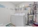 Functional laundry room with modern appliances, storage shelves, and practical organization tools at 13527 Willow Bluestar Loop, Riverview, FL 33579