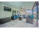 Inviting covered patio with cozy seating, a ceiling fan, and a wall-mounted TV for outdoor relaxation at 13527 Willow Bluestar Loop, Riverview, FL 33579