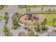 Aerial view of playground area with slides and climbing structures and sidewalk at 13527 Willow Bluestar Loop, Riverview, FL 33579