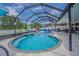 Stunning screened-in pool with a spa, lush landscaping, and ample space for outdoor enjoyment at 13527 Willow Bluestar Loop, Riverview, FL 33579