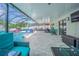 Expansive screened lanai with a sparkling pool, comfortable seating, and a covered dining area at 13527 Willow Bluestar Loop, Riverview, FL 33579