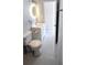 Bathroom featuring a modern, round, lighted mirror above a vanity at 1407 Coral Ridge Dr, Punta Gorda, FL 33950