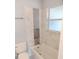 Updated bathroom featuring modern tile, a bathtub with shower, and a built-in niche for added convenience at 1407 Coral Ridge Dr, Punta Gorda, FL 33950