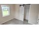 Cozy bedroom features tile floor and sliding door closet and bright window at 1407 Coral Ridge Dr, Punta Gorda, FL 33950