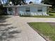 Attractive single-story home with a newly paved driveway and updated landscaping, complemented by a light blue exterior at 1407 Coral Ridge Dr, Punta Gorda, FL 33950