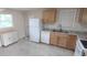 Bright kitchen with matching appliances, wooden cabinets, and tile floors at 1407 Coral Ridge Dr, Punta Gorda, FL 33950