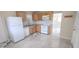 Functional kitchen with wooden cabinets, white appliances, granite countertops, and easy access to the living area at 1407 Coral Ridge Dr, Punta Gorda, FL 33950