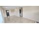 Spacious living room featuring light-colored tile flooring, neutral paint, base molding, and an open layout at 1407 Coral Ridge Dr, Punta Gorda, FL 33950