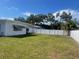 Spacious fenced backyard with lush green grass and ample room for outdoor activities at 1480 Fairfield Dr, Clearwater, FL 33764