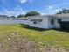 Large backyard featuring a well-maintained lawn, offering plenty of space and privacy at 1480 Fairfield Dr, Clearwater, FL 33764