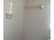 Bathroom featuring white tiled walls and a soap dish and towel bar at 1480 Fairfield Dr, Clearwater, FL 33764