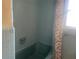 Vintage bathroom featuring blue tiling and a bathtub with shower curtain at 1480 Fairfield Dr, Clearwater, FL 33764