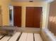 Bedroom featuring carpeted floors, closet, and a door to the hallway at 1480 Fairfield Dr, Clearwater, FL 33764