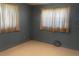 Bedroom with blue walls, two large windows, and carpeting at 1480 Fairfield Dr, Clearwater, FL 33764
