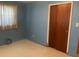 Bedroom with light blue walls, carpeting, and a closet at 1480 Fairfield Dr, Clearwater, FL 33764