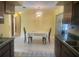 Bright dining area near kitchen with room for a table set for two and a vintage chandelier at 1480 Fairfield Dr, Clearwater, FL 33764