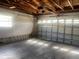 Open garage space with exposed ceiling and concrete floor, offering ample room for parking and storage at 1480 Fairfield Dr, Clearwater, FL 33764