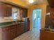 Practical kitchen layout with a sink and microwave, a view into the laundry room and ample cabinet space at 1480 Fairfield Dr, Clearwater, FL 33764
