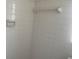 Bathroom shower featuring white tile and a wall-mounted soap dish at 1480 Fairfield Dr, Clearwater, FL 33764