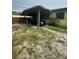 Covered carport area providing parking and shelter, attached to the side of the single-Gathering home at 1557 15Th S St, St Petersburg, FL 33705