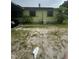 Side view of the single-Gathering home showing the backyard, carport access, and external features at 1557 15Th S St, St Petersburg, FL 33705