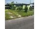 Quaint single-Gathering home features a carport, mature landscaping, and a cozy front entrance at 1557 15Th S St, St Petersburg, FL 33705