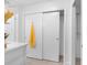 Clean bathroom with storage, a sliding closet door and modern fixtures at 1675 E Grovehill Rd, Palm Harbor, FL 34683
