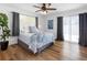 Bright bedroom with a comfortable bed, ceiling fan, and plenty of natural light at 1675 E Grovehill Rd, Palm Harbor, FL 34683