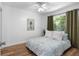 Cozy bedroom with plush bed, ample natural light, and a ceiling fan at 1675 E Grovehill Rd, Palm Harbor, FL 34683