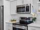 Close-up of modern stainless steel appliances, including a microwave and oven, in a well-equipped kitchen at 1675 E Grovehill Rd, Palm Harbor, FL 34683