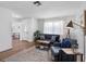 Stylish living room showcasing hardwood floors, a comfortable sofa, and ample natural light at 1675 E Grovehill Rd, Palm Harbor, FL 34683