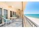 Enjoy a relaxing beach view from this balcony with seating, ceiling fan, and large sliders for indoor/outdoor living at 17720 Gulf Blvd # A702, Redington Shores, FL 33708