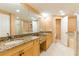 Bright bathroom featuring double sinks, granite countertops, tile flooring, and a large mirror at 17720 Gulf Blvd # A702, Redington Shores, FL 33708