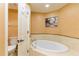 Elegant bathroom featuring a walk-in shower, soaking tub, tile flooring, and granite countertops at 17720 Gulf Blvd # A702, Redington Shores, FL 33708