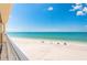 Balcony view of a pristine white sandy beach with clear blue ocean waters at 17720 Gulf Blvd # A702, Redington Shores, FL 33708