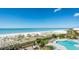 Balcony view overlooking the ocean and a pool with lounge chairs at 17720 Gulf Blvd # A702, Redington Shores, FL 33708