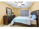 Cozy bedroom featuring a ceiling fan, comfortable bed, dresser, mirror, and tile flooring at 17720 Gulf Blvd # A702, Redington Shores, FL 33708