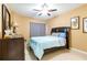 Inviting bedroom featuring a ceiling fan, comfortable bed, dresser, mirror, and tile floors at 17720 Gulf Blvd # A702, Redington Shores, FL 33708