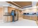 Spacious kitchen featuring wooden cabinetry, granite countertops, stainless steel appliances, and ample storage space at 17720 Gulf Blvd # A702, Redington Shores, FL 33708