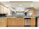 Bright kitchen featuring light wood cabinets, granite countertops, stainless steel appliances, and bar seating at 17720 Gulf Blvd # A702, Redington Shores, FL 33708